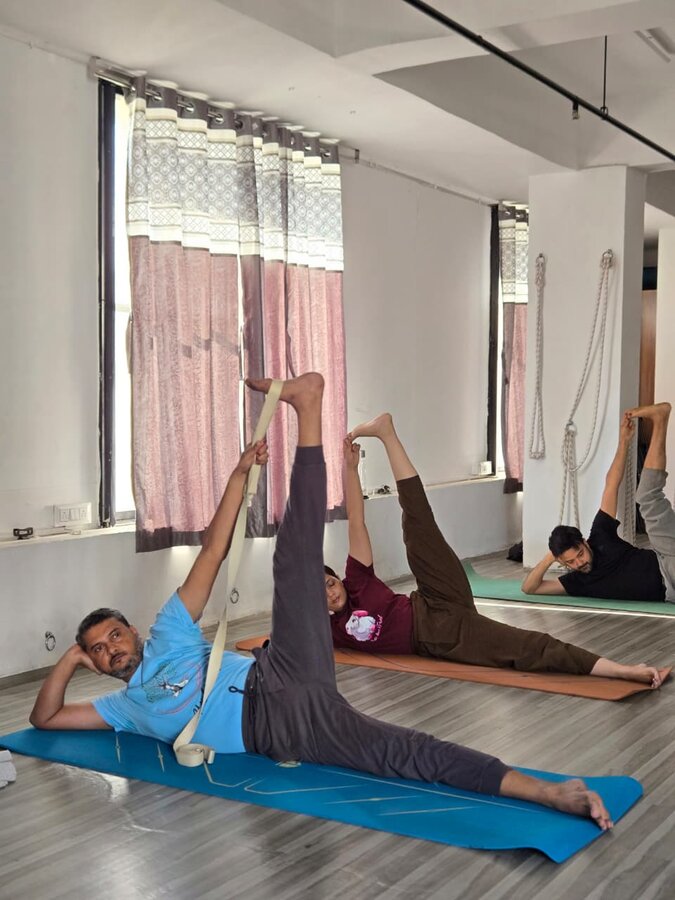 Students practicing an asana stretch at YogStudio